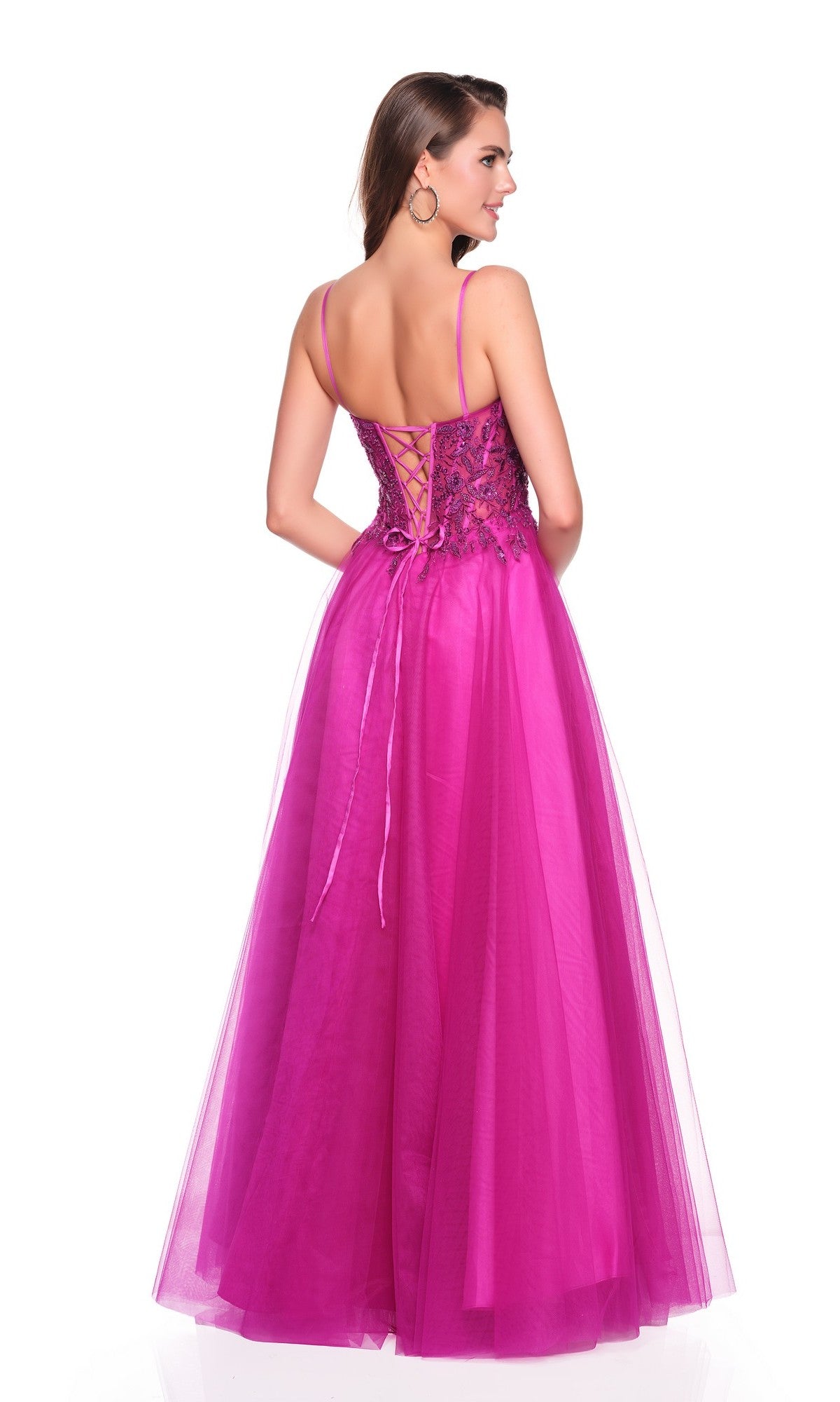 A woman wearing the Dave and Johnny 12582 long prom dress—sleeveless magenta with embroidered corset bodice, lace-up back, and flowing tulle A-line skirt—stands facing away from the camera.